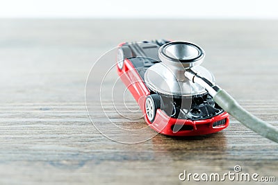 Stethoscope checking up the car on wooden table, Concept of car Stock Photo