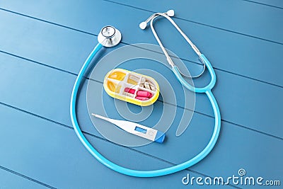 stethoscope with a digital thermometer and pills on the table, a still life showing the career and work of cardiologist or Stock Photo