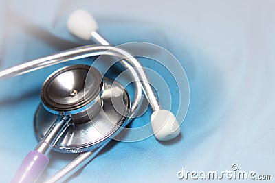 Stethoscope for doctor checkup on health blue medical laboratory table background. vignette Stock Photo