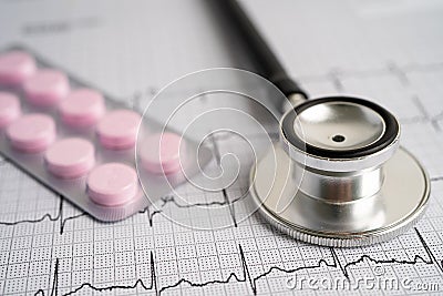 Stethoscope on electrocardiogram with capsule pill, heart wave, heart attack, cardiogram report Stock Photo