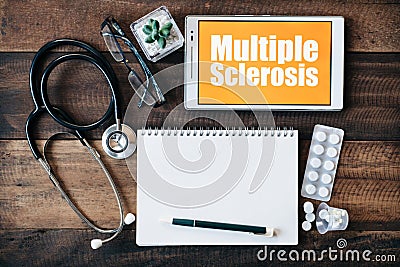 Stethoscope, eyeglass, blank notebook, medicine and digital tablet with MULTIPLE SCLEROSIS word Stock Photo