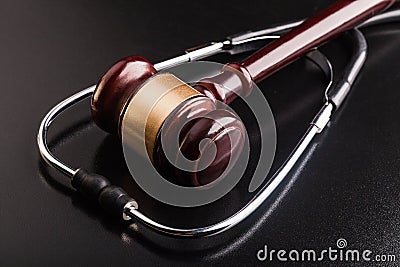 Wooden gavel and stethoscope, close-up view Stock Photo