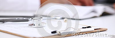 Stethoscope head lying on medical forms closeup Stock Photo