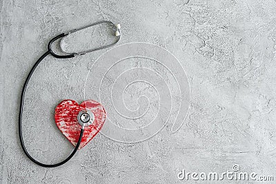 Stethoscope and heart on a gray background Stock Photo
