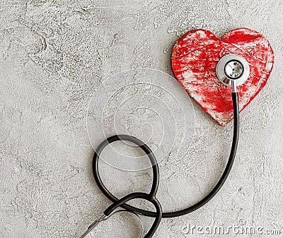 Stethoscope and heart on a gray background Stock Photo