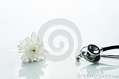 Stethoscope for medical doctor health in diagnosis in hospital or clinic with white natural flower clean background Stock Photo