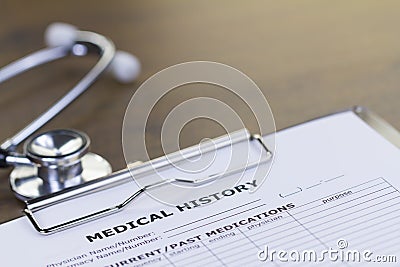 Stethoscope and Medical History Report Stock Photo