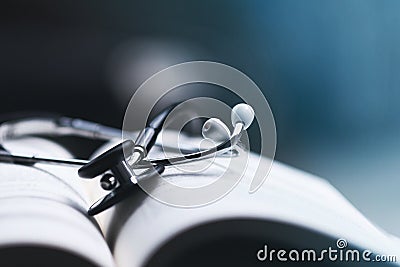 Stethoscope on medical textbooks in library Stock Photo