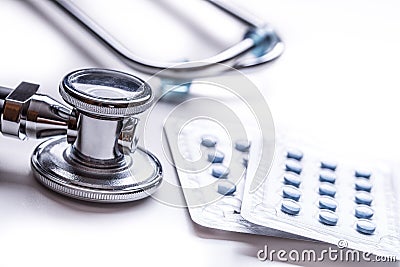 Stethoscope. Medical tool stethoscop with pills and red heart Stock Photo