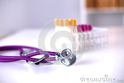 Stethoscope near medical tubes on white background Stock Photo