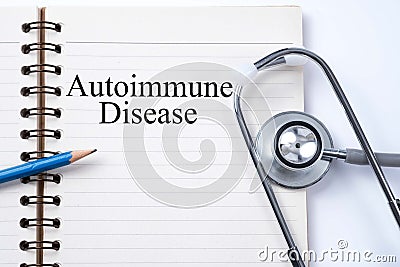 Stethoscope on notebook and pencil with Autoimmune Disease words Stock Photo