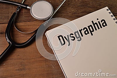 Stethoscope and notebook written with DYSGRAPHIA Stock Photo