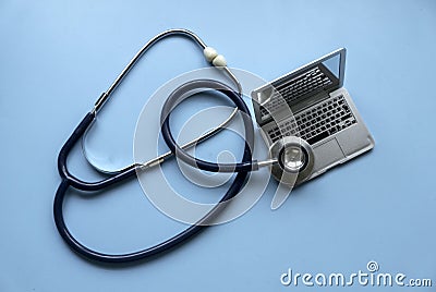 Stethoscope over a laptop over a blue background Stock Photo