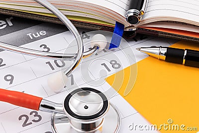 Stethoscope, pen and paper note on calendar, doctor appointment. Stock Photo