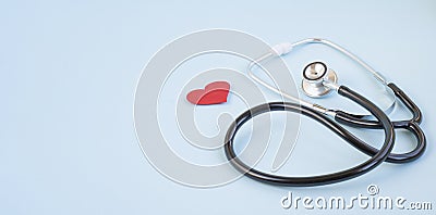 Stethoscope and red heart on a blue background. Greeting background. Stock Photo