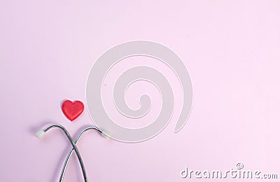 Top view Stethoscope and red heart on pale pink isolated background with copy space for text. Close up, top view. Medical equipme Stock Photo