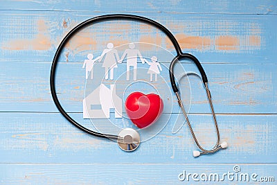 Stethoscope with Red heart shape, Family and House paper on blue pastel color wooden Stock Photo