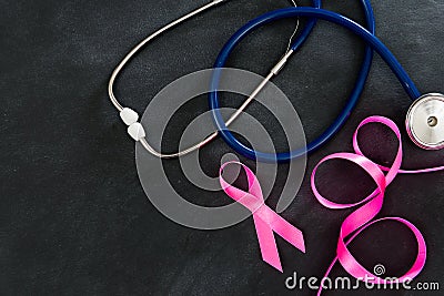 Stethoscope with ribbon on blackboard background Stock Photo