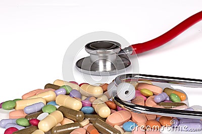 Stethoscope and some colorful pills isolated on white Stock Photo