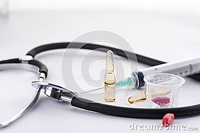 Stethoscope, syringe, ampules and pills Stock Photo
