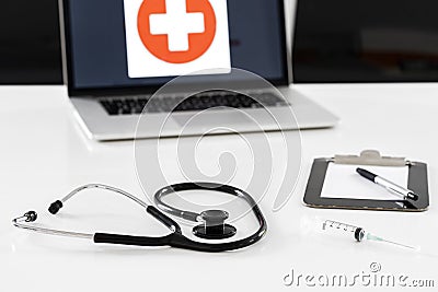 Stethoscope, syringe and mask on doctor desk Stock Photo