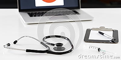 Stethoscope, syringe and mask on doctor desk Stock Photo