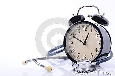 stethoscope and vintage clock face simulating medical appointment for health concept Stock Photo