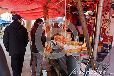 Steveston Harbour Fisherman Wharf. Fishermen sell fish on the boat. People wearing face mask during covid-19 pandemic period. Editorial Stock Photo