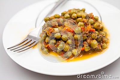 Stew with peas, carrots, onions and tomato sauce Stock Photo
