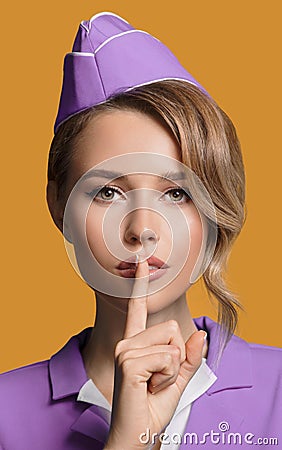 Stewardess showing silence gesture. Stock Photo