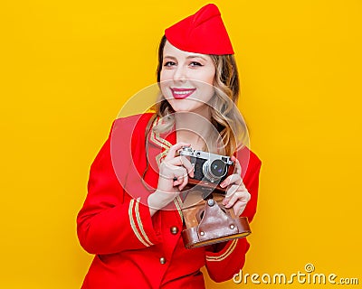 Stewardess wearing in red uniform with photo camera Stock Photo