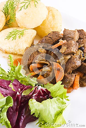 Stewed beef steak with potatoes and salad Stock Photo