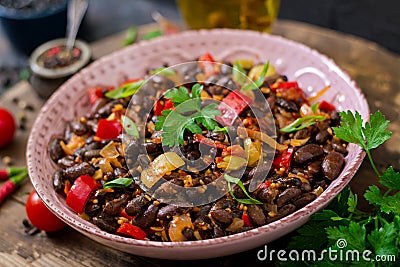 Stewed black beans with sweet peppers and tomatoes with spicy sauce Stock Photo