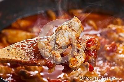 Stewed chicken in tomato sauce Stock Photo