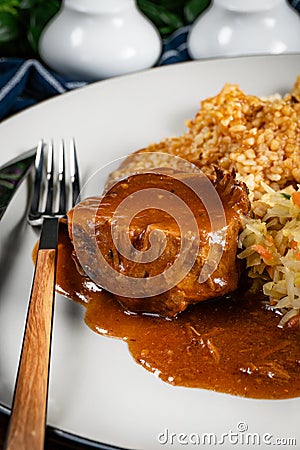 Stewed pork neck in gravy served with barley groats Stock Photo