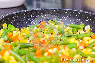Stewed sliced vegetables in a pan Stock Photo