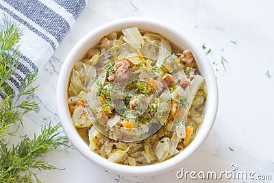 Stewed young cabbage with dill and sausage Stock Photo