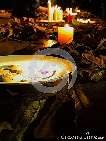 stic candles on the wooden platform with aurumn leaves Stock Photo