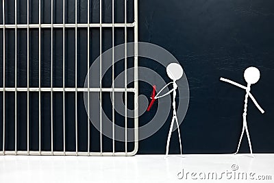 Stick figure victim pointing on a handcuffed suspect man tied with red rope going to a jail prison in dark background. Stock Photo