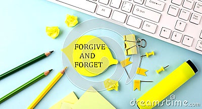 Sticker with FORGIVE AND FORGET text on notebooks on the white background Stock Photo