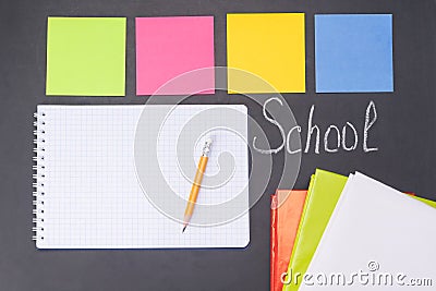 Stickers and an empty sheet for entries on a board on which chalk is written `back to school` Stock Photo