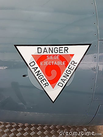 Stickers sign on plane write in french siÃ¨ge Ã©jectable danger means ejection seat danger Stock Photo