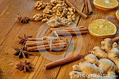 Sticks of cinnamon and anise stars on wooden brown background. Ingredients for mulled wine: dried fruits, orange, ginger, cinnamon Stock Photo