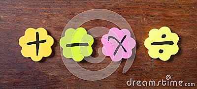 Sticky colorful notes in flower shape, , with math symbols on wooden background. Stock Photo