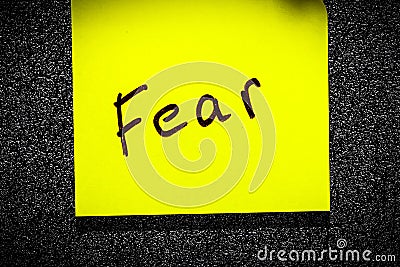 sticky leaf on the wall. inscription marker word fear Stock Photo