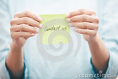 Sticky note with Contact us text Stock Photo