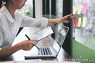 Sticky note paper reminder schedule board, Business woman accountant working audit and calculating expense financial annual Stock Photo