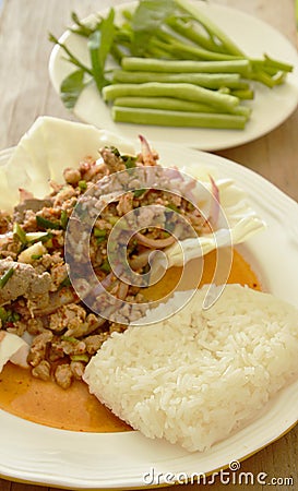 Sticky rice eat with Thai spicy minced pork salad and fresh vegetable Stock Photo