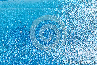 Sticky snow on the blue surface. Ice, cold Stock Photo