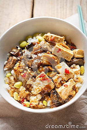 Sticky teriyaki tofu with rice, edamame beans and red chillies Stock Photo